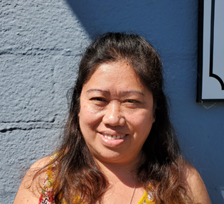 Smiling woman with dark hair.