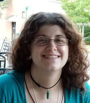 Smiling woman with curly hair.